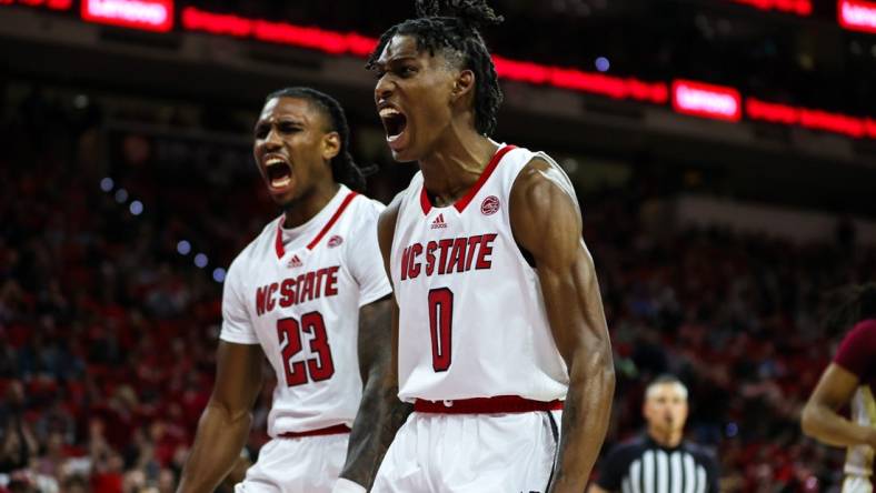 Feb 1, 2023; Raleigh, North Carolina, USA; North Carolina State Wolfpack guard Terquavion Smith (0) and North Carolina State Wolfpack forward Greg Gantt (23) react to a basket scored during the first half against Florida State at PNC Arena.  Mandatory Credit: Jaylynn Nash-USA TODAY Sports