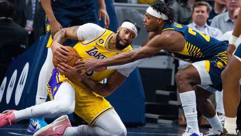 Feb 2, 2023; Indianapolis, Indiana, USA; Los Angeles Lakers forward Anthony Davis (3) grabs a loose the ball while Indiana Pacers guard Buddy Hield (24) defends in the first quarter at Gainbridge Fieldhouse. Mandatory Credit: Trevor Ruszkowski-USA TODAY Sports