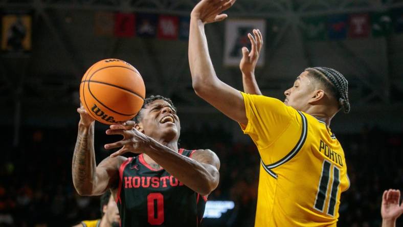 Jan 25, 2023; Wichita, Kansas, USA; Houston Cougars guard Marcus Sasser (0) puts up a shot over Wichita State Shockers forward Kenny Pohto (11) during the first half at Charles Koch Arena. Mandatory Credit: William Purnell-USA TODAY Sports