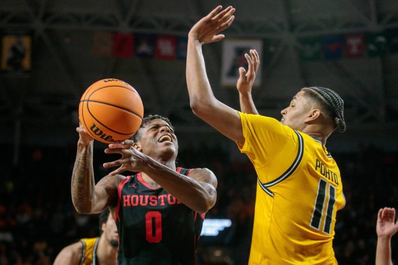 Jan 25, 2023; Wichita, Kansas, USA; Houston Cougars guard Marcus Sasser (0) puts up a shot over Wichita State Shockers forward Kenny Pohto (11) during the first half at Charles Koch Arena. Mandatory Credit: William Purnell-USA TODAY Sports