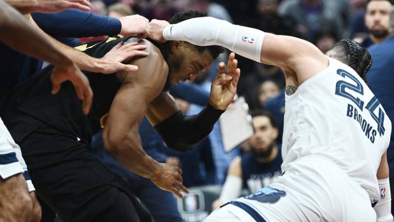 Feb 2, 2023; Cleveland, Ohio, USA; Cleveland Cavaliers guard Donovan Mitchell (45) fights with Memphis Grizzlies forward Dillon Brooks (24) during the second half at Rocket Mortgage FieldHouse. Both players were ejected. Mandatory Credit: Ken Blaze-USA TODAY Sports