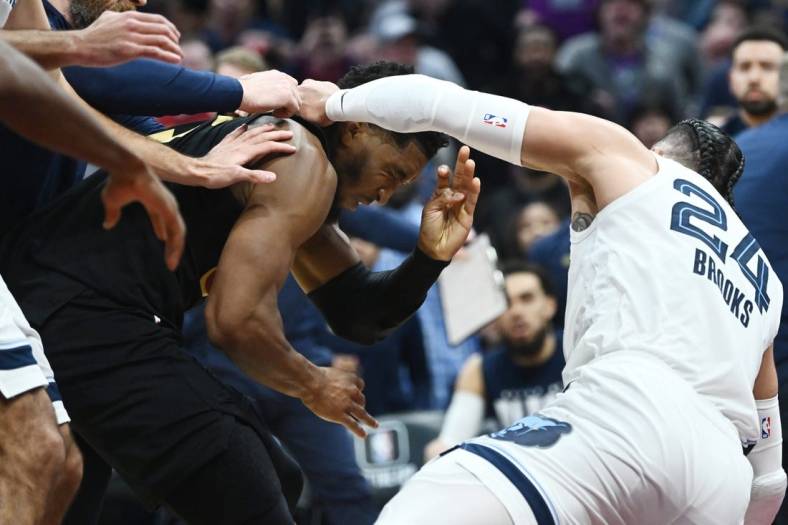 Feb 2, 2023; Cleveland, Ohio, USA; Cleveland Cavaliers guard Donovan Mitchell (45) fights with Memphis Grizzlies forward Dillon Brooks (24) during the second half at Rocket Mortgage FieldHouse. Both players were ejected. Mandatory Credit: Ken Blaze-USA TODAY Sports
