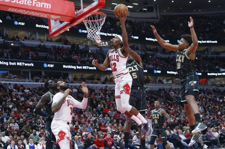 Feb 2, 2023; Chicago, Illinois, USA; Chicago Bulls guard Ayo Dosunmu (12) goes to the basket against the Charlotte Hornets during the first half at United Center. Mandatory Credit: Kamil Krzaczynski-USA TODAY Sports
