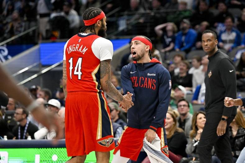 Feb 2, 2023; Dallas, Texas, USA; New Orleans Pelicans guard Jose Alvarado (15) celebrates as forward Brandon Ingram (14) comes off the court during the second half of the game against the Dallas Mavericks at the American Airlines Center. Mandatory Credit: Jerome Miron-USA TODAY Sports