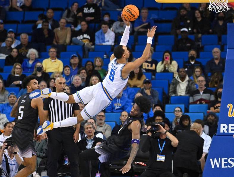 Feb 2, 2023; Los Angeles, California, USA; UCLA Bruins guard Amari Bailey (5) is charged with an offensive foul on Washington Huskies forward Keion Brooks (1) in the second half at Pauley Pavilion presented by Wescom. Mandatory Credit: Jayne Kamin-Oncea-USA TODAY Sports