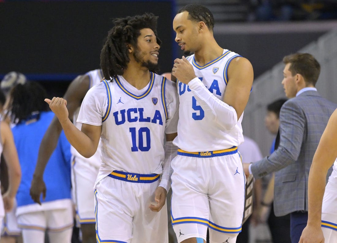 Feb 2, 2023; Los Angeles, California, USA; UCLA Bruins guard Tyger Campbell (10) and guard Amari Bailey (5) talk during a time out in the second half against the Washington Huskies at Pauley Pavilion presented by Wescom. Mandatory Credit: Jayne Kamin-Oncea-USA TODAY Sports