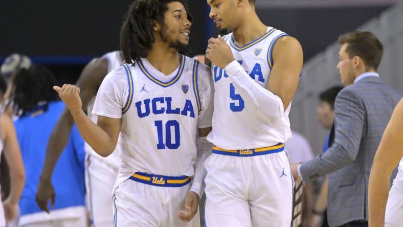 Feb 2, 2023; Los Angeles, California, USA; UCLA Bruins guard Tyger Campbell (10) and guard Amari Bailey (5) talk during a time out in the second half against the Washington Huskies at Pauley Pavilion presented by Wescom. Mandatory Credit: Jayne Kamin-Oncea-USA TODAY Sports