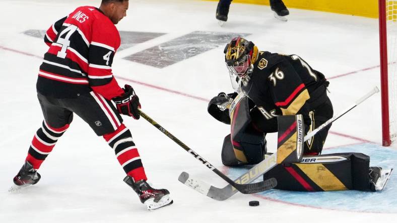 Feb 3, 2023; Sunrise, Florida, USA; Chicago Blackhawks defensemen Seth Jones (4) shoots the puck against Winnipeg Jets goaltender Connor Hellebuyck (37) during the 2023 NHL All-Star Skills Competition at FLA Live Arena. Mandatory Credit: Jasen Vinlove-USA TODAY Sports