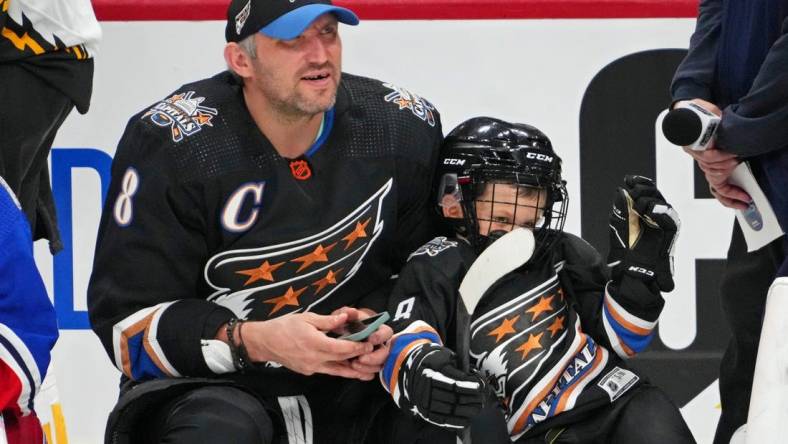 Feb 3, 2023; Sunrise, Florida, USA; Washington Capitals left wing Alex Ovechkin (8) with his son Sergei during the 2023 NHL All-Star Skills Competition at FLA Live Arena. Mandatory Credit: Jasen Vinlove-USA TODAY Sports