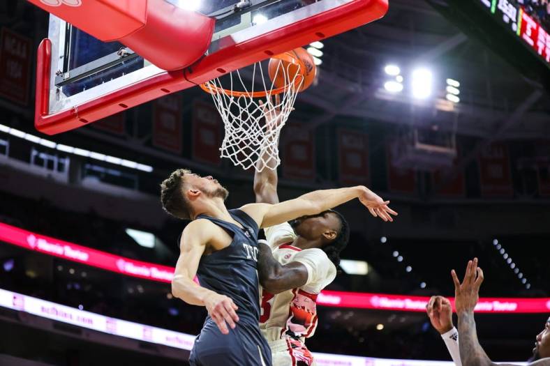 Feb 4, 2023; Raleigh, North Carolina, USA; North Carolina State Wolfpack forward Greg Gantt (23) is fouled by Georgia Tech Yellow Jackets guard Lance Terry (0) during first half against at PNC Arena. Mandatory Credit: Jaylynn Nash-USA TODAY Sports