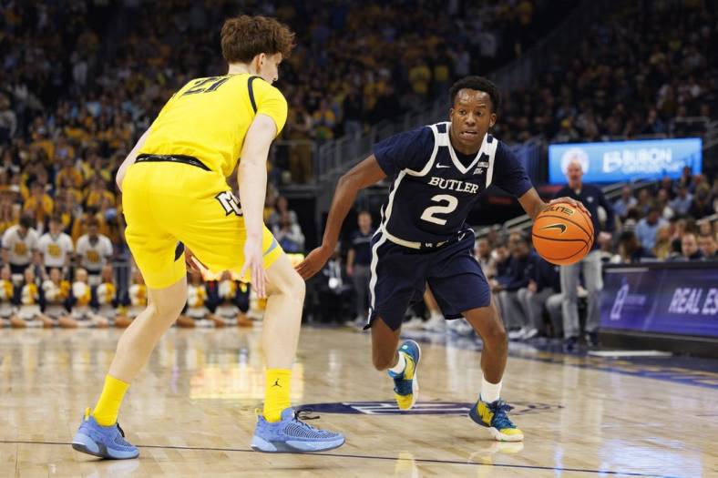 Feb 4, 2023; Milwaukee, Wisconsin, USA;  Butler Bulldogs guard Eric Hunter Jr. (2) drives towards the basket against Marquette Golden Eagles forward Ben Gold (21) during the first half at Fiserv Forum. Mandatory Credit: Jeff Hanisch-USA TODAY Sports