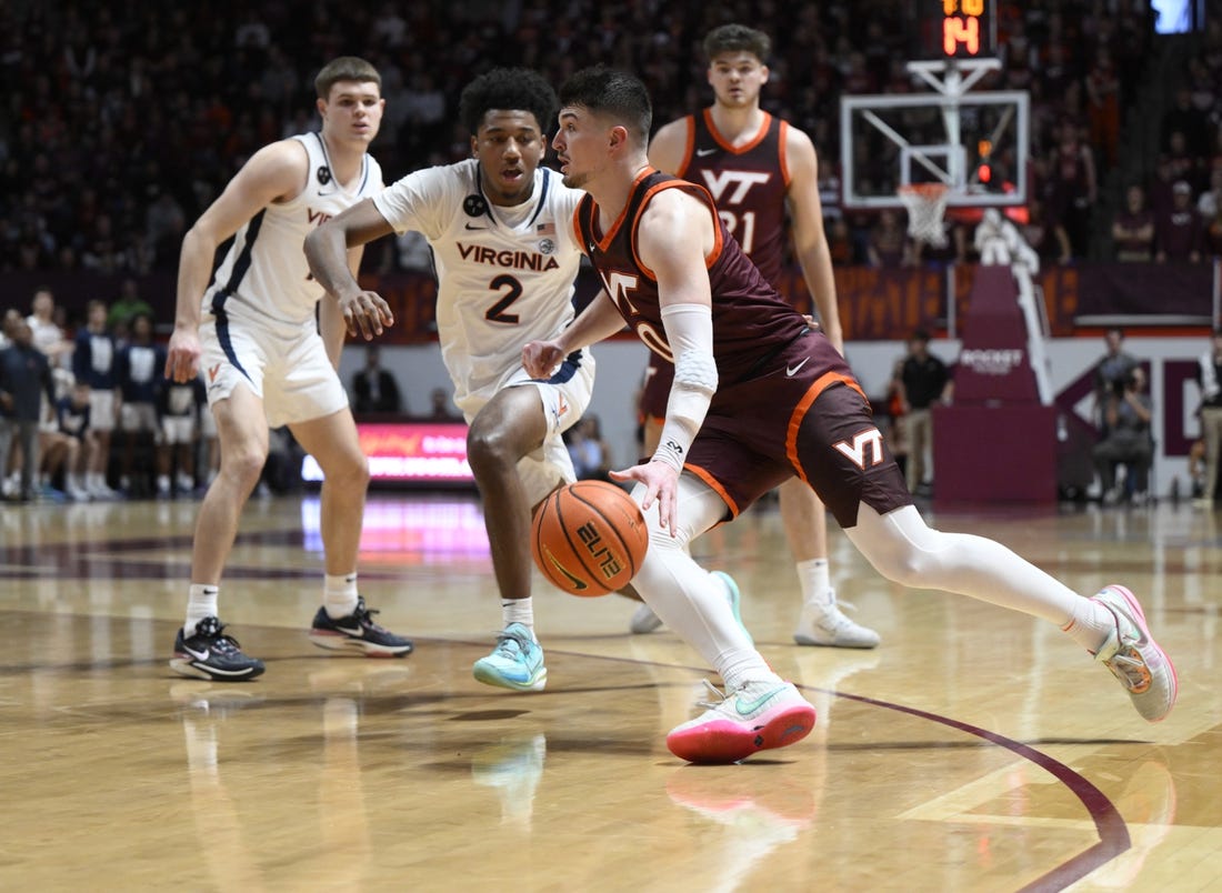 Feb 4, 2023; Blacksburg, Virginia, USA;  Virginia Tech Hokies guard Hunter Cattoor (0) dribbles around Boston College Eagles guard Michael Collins Jr. (2) in the second half at Cassell Coliseum. Mandatory Credit: Lee Luther Jr.-USA TODAY Sports