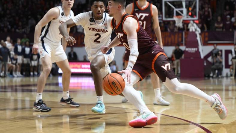 Feb 4, 2023; Blacksburg, Virginia, USA;  Virginia Tech Hokies guard Hunter Cattoor (0) dribbles around Boston College Eagles guard Michael Collins Jr. (2) in the second half at Cassell Coliseum. Mandatory Credit: Lee Luther Jr.-USA TODAY Sports