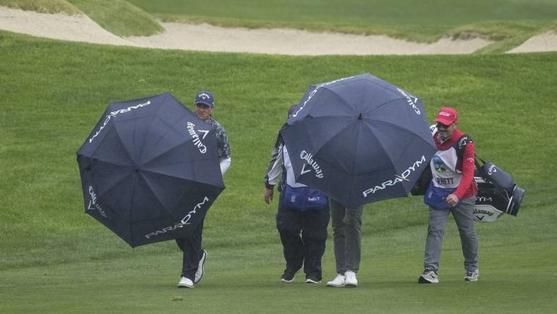 Feb 4, 2023; Pebble Beach, California, USA; Brian Stuard (left) walks with his group up the ninth fairway during the third round of the AT&T Pebble Beach Pro-Am golf tournament at Spyglass Hill Golf Course. Mandatory Credit: Ray Acevedo-USA TODAY Sports