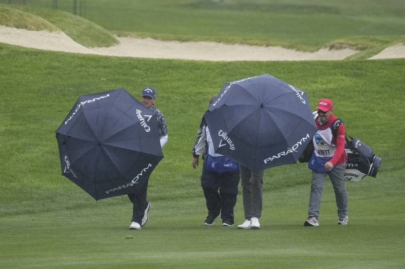 Feb 4, 2023; Pebble Beach, California, USA; Brian Stuard (left) walks with his group up the ninth fairway during the third round of the AT&T Pebble Beach Pro-Am golf tournament at Spyglass Hill Golf Course. Mandatory Credit: Ray Acevedo-USA TODAY Sports