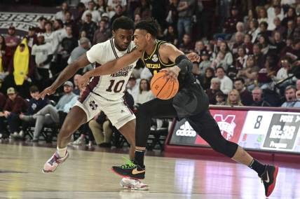 Feb 4, 2023; Starkville, Mississippi, USA;  Missouri Tigers guard DeAndre Gholston (4) handles the ball while defended by Mississippi State Bulldogs guard Dashawn Davis (10) during the first half at Humphrey Coliseum. Mandatory Credit: Matt Bush-USA TODAY Sports