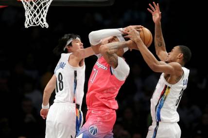 Feb 4, 2023; Brooklyn, New York, USA; Washington Wizards center Daniel Gafford (21) fights for the ball against Brooklyn Nets forward Yuta Watanabe (18) and center Nic Claxton (33) during the first quarter at Barclays Center. Mandatory Credit: Brad Penner-USA TODAY Sports