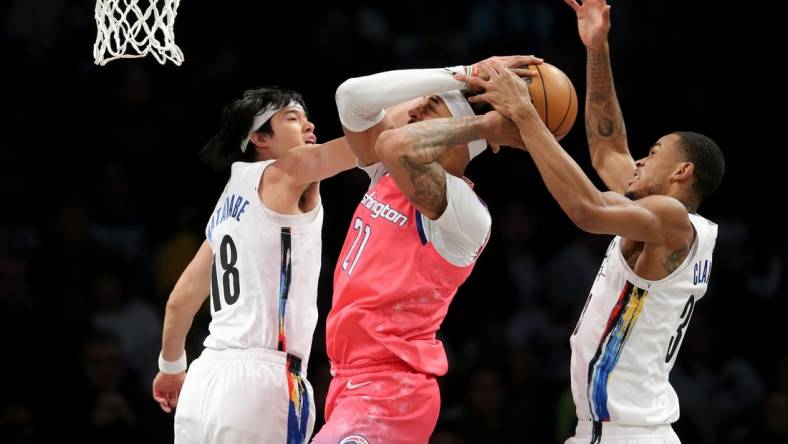 Feb 4, 2023; Brooklyn, New York, USA; Washington Wizards center Daniel Gafford (21) fights for the ball against Brooklyn Nets forward Yuta Watanabe (18) and center Nic Claxton (33) during the first quarter at Barclays Center. Mandatory Credit: Brad Penner-USA TODAY Sports