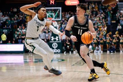Feb 4, 2023; Fort Collins, Colorado, USA; Utah State Aggies guard Max Shulga (11) drives to the net against Colorado State Rams guard John Tonje (1) in the first half at Moby Arena. Mandatory Credit: Isaiah J. Downing-USA TODAY Sports