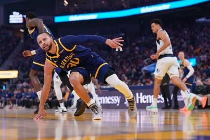 Feb 4, 2023; San Francisco, California, USA; Golden State Warriors guard Stephen Curry (30) regains his footing after being knocked to the ground against the Dallas Mavericks in the first quarter at the Chase Center. Mandatory Credit: Cary Edmondson-USA TODAY Sports