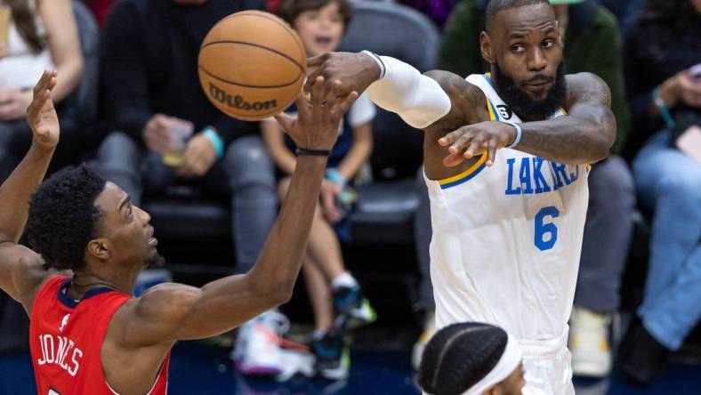 Feb 4, 2023; New Orleans, Louisiana, USA;  Los Angeles Lakers forward LeBron James (6) passes the ball against New Orleans Pelicans forward Herbert Jones (5) during the second half at Smoothie King Center. Mandatory Credit: Stephen Lew-USA TODAY Sports