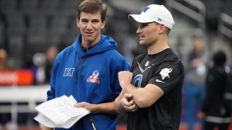 Feb 4, 2023; Paradise, NV, USA; NFL coach Eli Manning (left) talks with Minnesota Vikings quarterback Kirk Cousins (8) during practice at Allegiant Stadium. Mandatory Credit: Kirby Lee-USA TODAY Sports