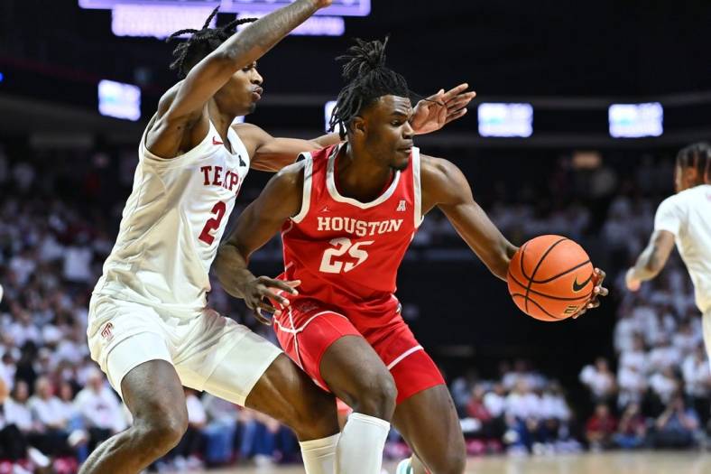 Feb 5, 2023; Philadelphia, Pennsylvania, USA; Houston Cougars forward Jarace Walker (25) controls the ball against Temple Owls guard Jahlil White (2) in the first half at The Liacouras Center. Mandatory Credit: Kyle Ross-USA TODAY Sports