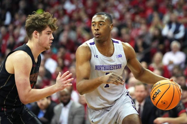 Feb 5, 2023; Madison, Wisconsin, USA; Northwestern Wildcats guard Chase Audige (1) dribbles the ball while defended by Wisconsin Badgers guard Max Klesmit (11) during the first half at the Kohl Center. Mandatory Credit: Kayla Wolf-USA TODAY Sports