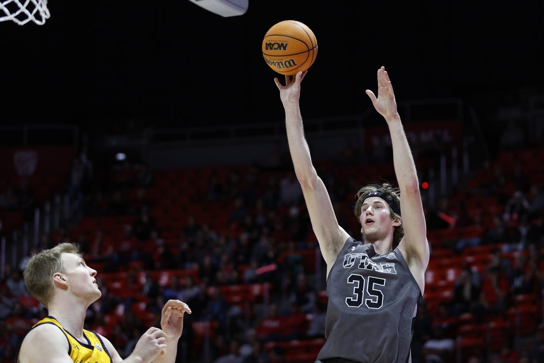 Feb 5, 2023; Salt Lake City, Utah, USA; Utah Utes center Branden Carlson (35) shoots over California Golden Bears forward Lars Thiemann (21) in the second half at Jon M. Huntsman Center. Mandatory Credit: Jeffrey Swinger-USA TODAY Sports