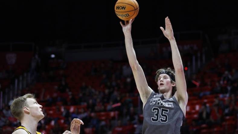 Feb 5, 2023; Salt Lake City, Utah, USA; Utah Utes center Branden Carlson (35) shoots over California Golden Bears forward Lars Thiemann (21) in the second half at Jon M. Huntsman Center. Mandatory Credit: Jeffrey Swinger-USA TODAY Sports