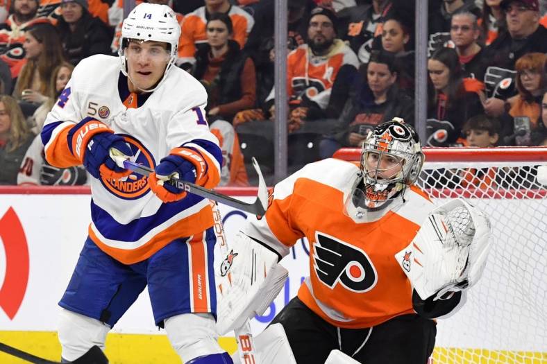 Feb 6, 2023; Philadelphia, Pennsylvania, USA; New York Islanders center Bo Horvat (14) tries to deflect the puck in front of Philadelphia Flyers goaltender Carter Hart (79) during the third period at Wells Fargo Center. Mandatory Credit: Eric Hartline-USA TODAY Sports