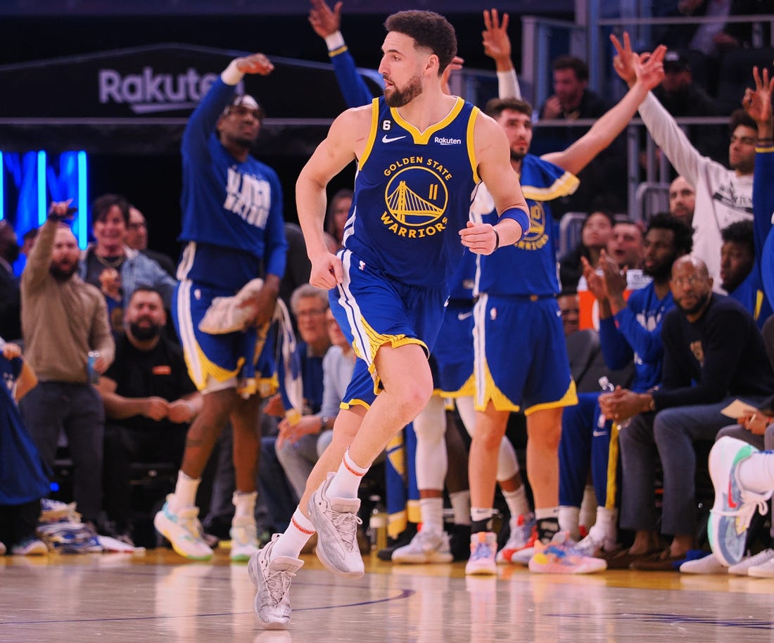 Feb 6, 2023; San Francisco, California, USA; The Golden State Warriors bench celebrates behind shooting guard Klay Thompson (11) after Thompson scored a three point basket against the Oklahoma City Thunder during the fourth quarter at Chase Center. Mandatory Credit: Kelley L Cox-USA TODAY Sports