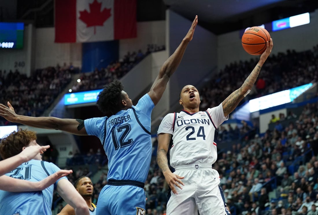 Feb 7, 2023; Hartford, Connecticut, USA; UConn Huskies guard Jordan Hawkins (24) shoots against Marquette Golden Eagles forward Olivier-Maxence Prosper (12) in the first half at XL Center. Mandatory Credit: David Butler II-USA TODAY Sports