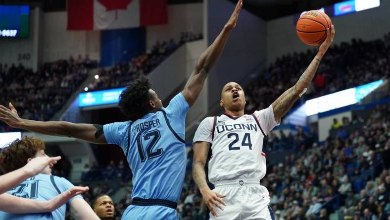 Feb 7, 2023; Hartford, Connecticut, USA; UConn Huskies guard Jordan Hawkins (24) shoots against Marquette Golden Eagles forward Olivier-Maxence Prosper (12) in the first half at XL Center. Mandatory Credit: David Butler II-USA TODAY Sports