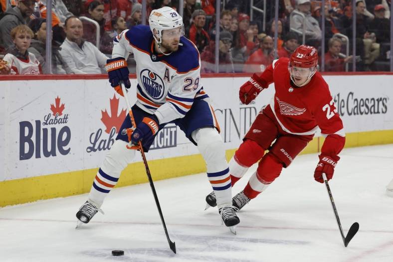 Feb 7, 2023; Detroit, Michigan, USA;  Edmonton Oilers center Leon Draisaitl (29) skates with the puck chased by Detroit Red Wings left wing Lucas Raymond (23) in the first period at Little Caesars Arena. Mandatory Credit: Rick Osentoski-USA TODAY Sports