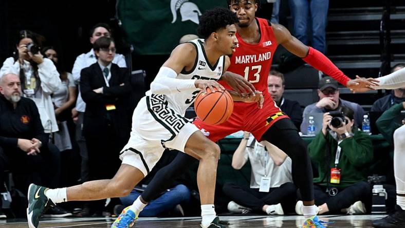 Feb 7, 2023; East Lansing, Michigan, USA;  Michigan State Spartans guard Jaden Akins (3) drives past Maryland Terrapins guard Hakim Hart (13) in the first half at Jack Breslin Student Events Center. Mandatory Credit: Dale Young-USA TODAY Sports