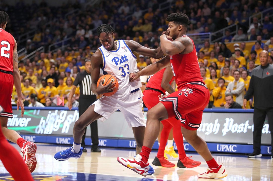 Pittsburgh Panthers Federiko Federiko (33) gets fouled by Louisville Cardinals Sydney Curry (21) while driving to the basket during the first half on February 7, 2023 at the Petersen Events Center in Pittsburgh, PA.

Pittsburgh Panthers Vs Louisville Mens Basketball