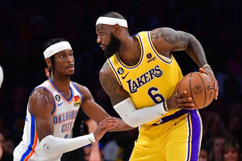 Feb 7, 2023; Los Angeles, California, USA; Oklahoma City Thunder guard Shai Gilgeous-Alexander (2) defends against Los Angeles Lakers forward LeBron James (6) in the second quarter at Crypto.com Arena. Mandatory Credit: Gary A. Vasquez-USA TODAY Sports