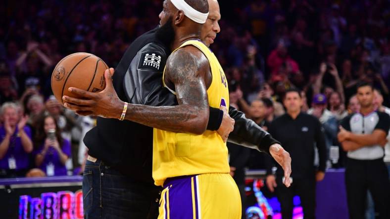 Feb 7, 2023; Los Angeles, California, USA; Former Los Angeles Lakers player Kareem Abdul-Jabbar hugs forward LeBron James (6) after James becomes the all time NBA scoring leader againt the Oklahoma City Thunder during the second half at Crypto.com Arena. Mandatory Credit: Gary A. Vasquez-USA TODAY Sports