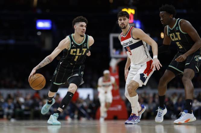 Feb 8, 2023; Washington, District of Columbia, USA; Charlotte Hornets guard LaMelo Ball (1) dribbles the ball as Washington Wizards forward Deni Avdija (9) defends in the second quarter at Capital One Arena. Mandatory Credit: Geoff Burke-USA TODAY Sports