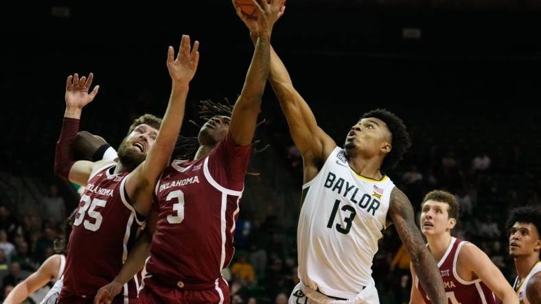 Feb 8, 2023; Waco, Texas, USA;  Baylor Bears guard Langston Love (13) battles for a rebound against Oklahoma Sooners guard Otega Oweh (3) and forward Tanner Groves (35) during the second half at Ferrell Center. Mandatory Credit: Chris Jones-USA TODAY Sports