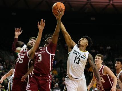 Feb 8, 2023; Waco, Texas, USA;  Baylor Bears guard Langston Love (13) battles for a rebound against Oklahoma Sooners guard Otega Oweh (3) and forward Tanner Groves (35) during the second half at Ferrell Center. Mandatory Credit: Chris Jones-USA TODAY Sports