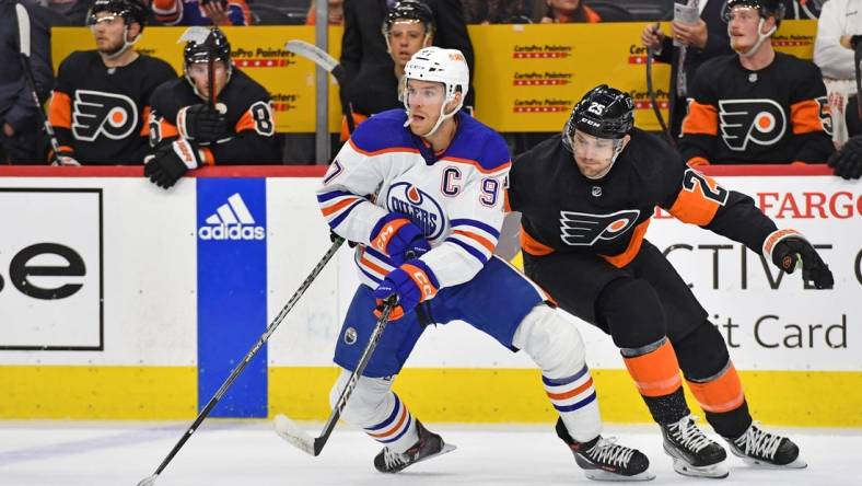 Feb 9, 2023; Philadelphia, Pennsylvania, USA; Edmonton Oilers center Connor McDavid (97) controls the puck against Philadelphia Flyers left wing James van Riemsdyk (25) during the second period at Wells Fargo Center. Mandatory Credit: Eric Hartline-USA TODAY Sports