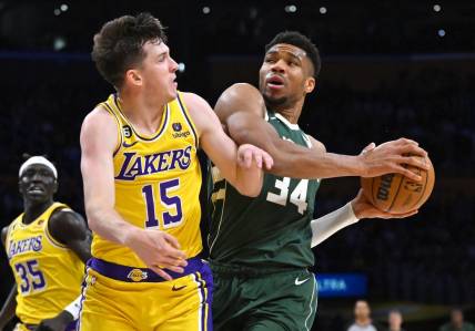 Feb 9, 2023; Los Angeles, California, USA;  Los Angeles Lakers guard Austin Reaves (15) defends Milwaukee Bucks forward Giannis Antetokounmpo (34) as he drives to the basket in the first half at Crypto.com Arena. Mandatory Credit: Jayne Kamin-Oncea-USA TODAY Sports