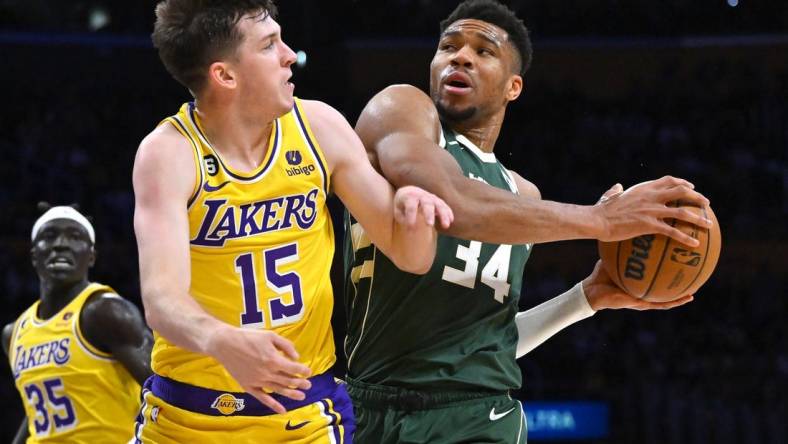 Feb 9, 2023; Los Angeles, California, USA;  Los Angeles Lakers guard Austin Reaves (15) defends Milwaukee Bucks forward Giannis Antetokounmpo (34) as he drives to the basket in the first half at Crypto.com Arena. Mandatory Credit: Jayne Kamin-Oncea-USA TODAY Sports