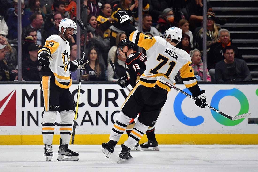 Feb 10, 2023; Anaheim, California, USA; Pittsburgh Penguins defenseman Pierre-Olivier Joseph (73) celebrates his goal scored against the Anaheim Ducks with center Evgeni Malkin (71) during the second period at Honda Center. Malkin provided an assist on the goal. Mandatory Credit: Gary A. Vasquez-USA TODAY Sports