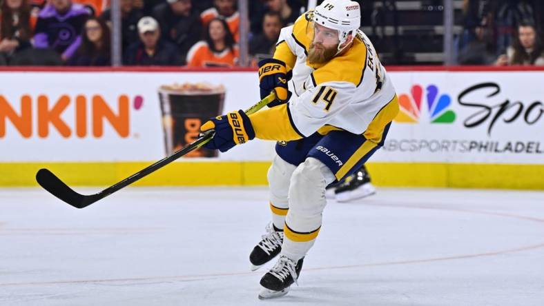 Feb 11, 2023; Philadelphia, Pennsylvania, USA; Nashville Predators defenseman Mattias Ekholm (14) clears the puck against the Philadelphia Flyers in the first period at Wells Fargo Center. Mandatory Credit: Kyle Ross-USA TODAY Sports