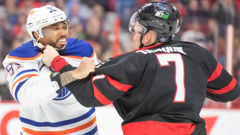 Feb 11, 2023; Ottawa, Ontario, CAN; Edmonton Oilers left wing Evander Kane (91) fights with  Ottawa Senators left wing Brady Tkachuk (7) in the second period at the Canadian Tire Centre. Mandatory Credit: Marc DesRosiers-USA TODAY Sports