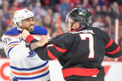Feb 11, 2023; Ottawa, Ontario, CAN; Edmonton Oilers left wing Evander Kane (91) fights with  Ottawa Senators left wing Brady Tkachuk (7) in the second period at the Canadian Tire Centre. Mandatory Credit: Marc DesRosiers-USA TODAY Sports