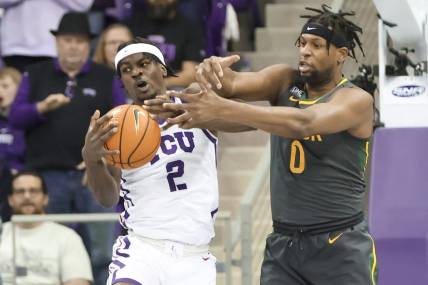 Feb 11, 2023; Fort Worth, Texas, USA;  TCU Horned Frogs forward Emanuel Miller (2) and Baylor Bears forward Flo Thamba (0) go for the ball during the first half at Ed and Rae Schollmaier Arena. Mandatory Credit: Kevin Jairaj-USA TODAY Sports